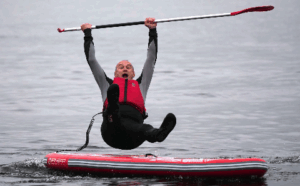 Ed Davey falling off paddle board into water